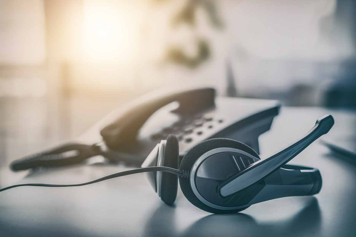 Phone and headset on table at call center